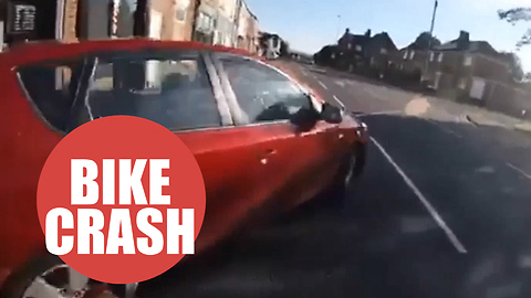 Cyclist nearly collides with a car after a reckless driver sharply pulls out