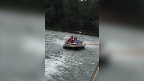 Two Girls Ride On A Inflatable Boat Behind A Speedboat And Fall Off