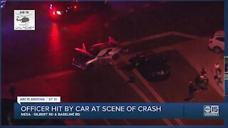 Mesa police officer hit by vehicle while on scene of a separate crash