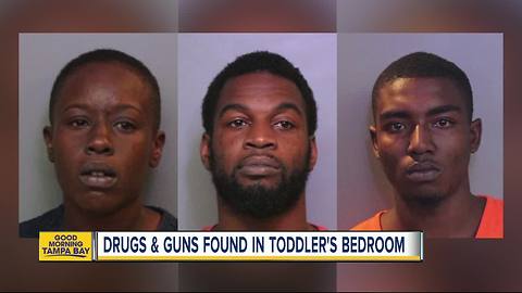 Police arrest four people after guns and drugs found near the bed where a toddler slept