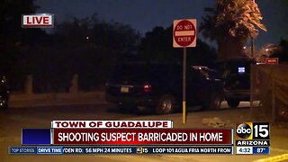 Shooting suspect barricaded in home