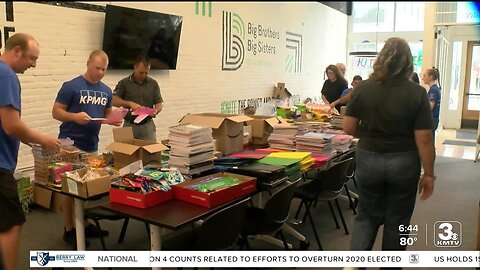 Omaha volunteers stuff backpacks with school supplies for local students in need