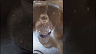 Filling a water bottle with drinking water