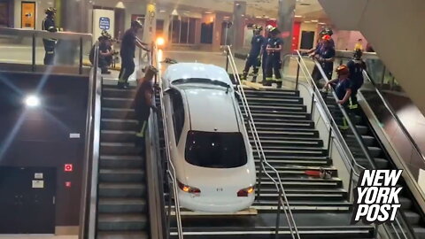 Stolen car gets stuck going up subway stairs