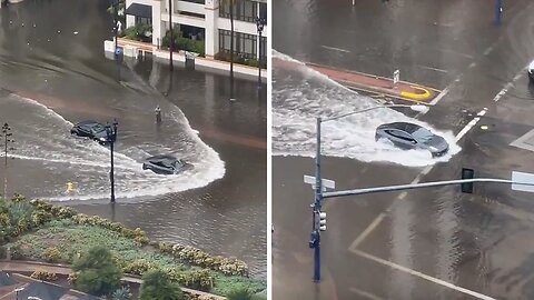 Incredible tesla car goes through extreme flooded street in San Diego