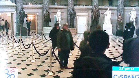 Two Capitol policeman stand by and offer no resistance as "breachers" walk through the Capitol