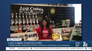 Log Cabin Chocolates says "We're Open Baltimore!"