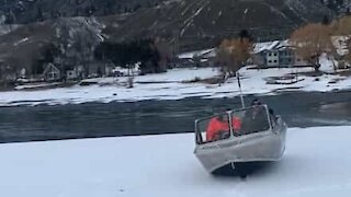 Boat slides across snow between two lakes!