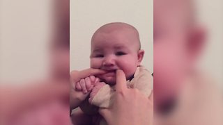 Adorable Baby Boy Chews On Mom’s Fingers