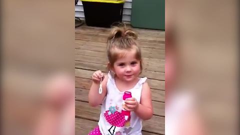 Lovely Tot Girl Blows Bubbles