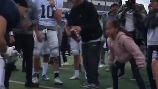 Little girl shows University Of Nevada football players how it's done