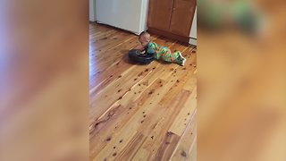 A Baby Boy Rides On A Roomba Vacuum