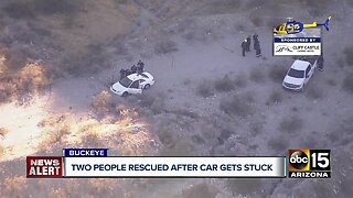2 people rescued after car gets stuck in wash