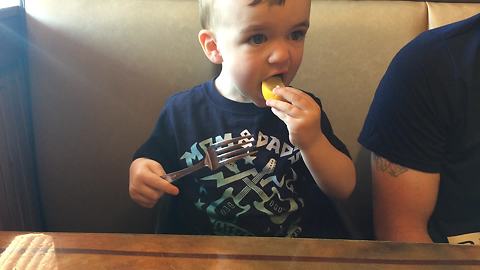 Cute Little Boy Is Having A Tough Time Deciding If He Like Or Hates Lemons