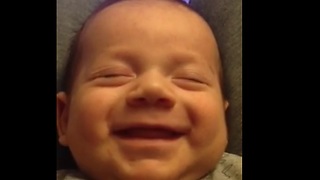 Baby boy preciously laughs in his sleep