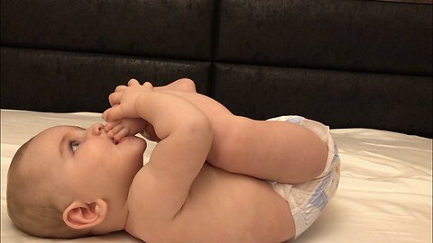 Cute Baby Boy Adorably Is Play With His Feets