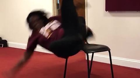 A Girl Fall Off A Chair While Doing A Dance Routine