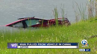 Man pulled from vehicle in canal off I-95