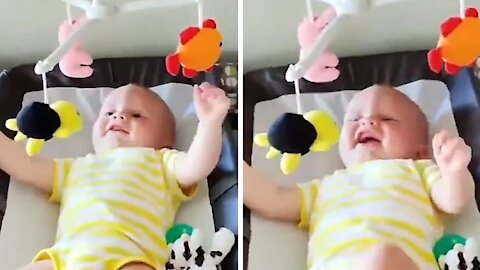 Baby in the crib starts to say thanks to get his mom's attention