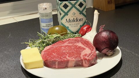 Ribeye Steak with Sautéed Onions Seared on a Cast Iron Skillet 4K Video