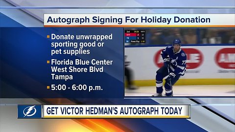 Tampa Bay Lightning defenseman Victor Hedman signing autographs for toy and pet supply donations