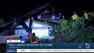 SUV lands on roof of home