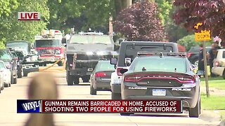Gunman remains barricaded in home, accused of shooting 2 people for using fireworks