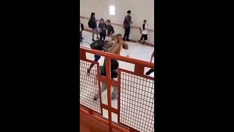 Teacher & student fist fighting in school hallway.