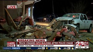 Truck crashes into apartment building during police chase