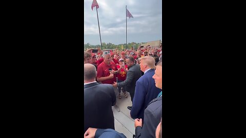 Trump shakes hands with fans as he makes his way through big crowds