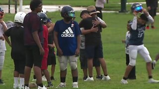 Coach teaches players the game of football an the importance of helping others