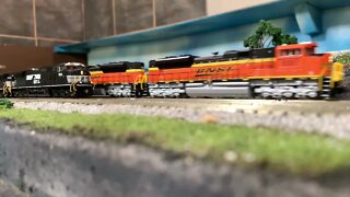 N Scale executive train passing a freighter