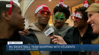Marquette men's basketball team shops with elementary students