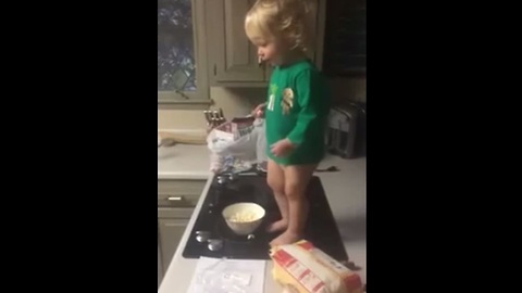 Baby tosses popcorn to dog in epic slow motion