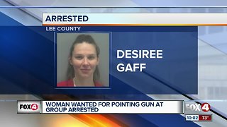 Woman arrested, wanted for pointing gun a group