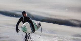 Surfers try to ride frozen waves in Massachusetts