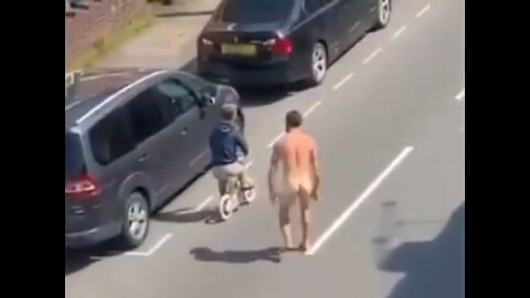 Crazy Naked man tries to attack dwarf riding a bicycle, maybe he got the vaccine. He needs Jesus!!