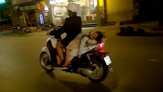 Little girl takes nap on back of speeding scooter