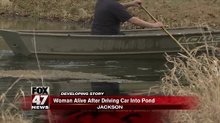Driver alive after driving into pond in Jackson