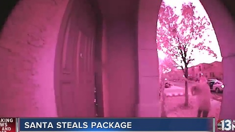Thief wearing Santa hat steals package off porch