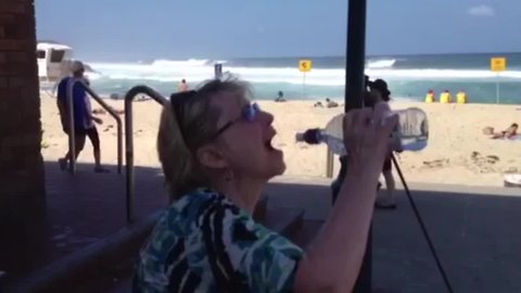 Woman Struggles with Water Bottle