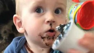 Little boy has great fun using coffee capsule as toy