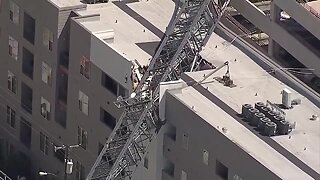 Crane collapses on Dallas apartment building, injuring some