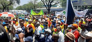 Members of the taxi industry make their way to the Union Buildings