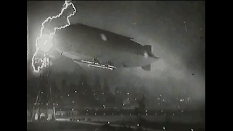 Zeppelin docked at a mooring mast, while lighting strikes.