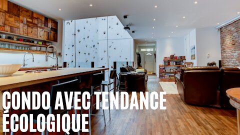 Tu peux louer un condo avec un immense mur d'escalade au milieu de la cuisine à Montréal