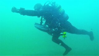 Scuba diver can't resist funny antics in fast flowing river