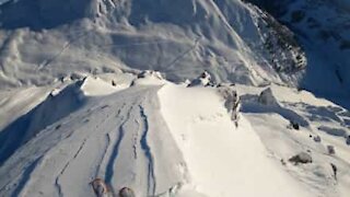Skier goes down breathtaking mountains in the Alps