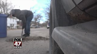 West Michigan boy fixes potholes on his own