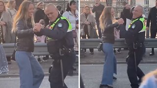 Police Officer Invites Woman To Dance During Oktoberfest